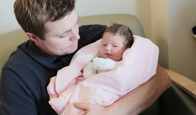 Father holding newborn baby